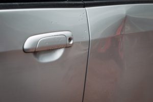 close up of damage on a silver vehicle